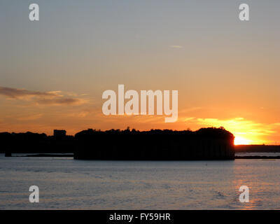 Sunset over the Fort Gorges is on Hog Island Ledge, in Casco Bay at the entrance to the harbor at Portland, Maine. Stock Photo