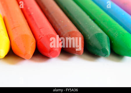 Macro of some colored wax crayons on a white background. Empty copy space for Publisher's text. Stock Photo