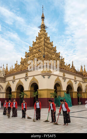 Burmese women sweep the floor around the Mahamuni Paya temple in Mandalay, Myanmar Stock Photo