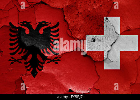 flags of Albania and Switzerland painted on cracked wall Stock Photo