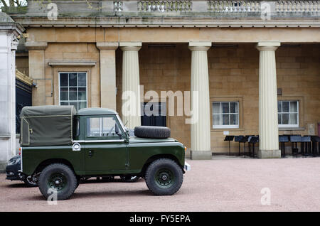 Land Rover Defender in the grounds of Buckingham Palace.Old style green short wheel-base vehicle parked in London home of Queen Stock Photo