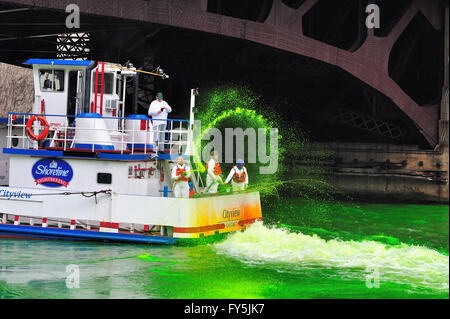 Crews dyeing the Chicago River green for the St. Patrick's Day holiday as thousands line the banks to watch. Chicago, Illinois, USA. Stock Photo