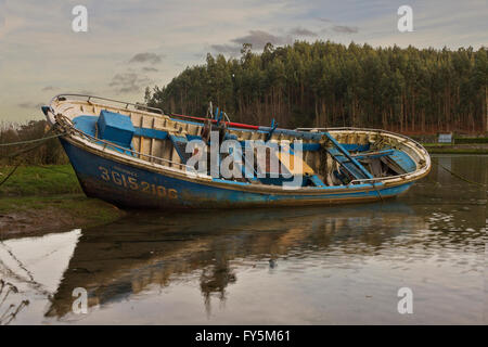 Old abandoned boat on the seashore in Asturias (Spain). Stock Photo