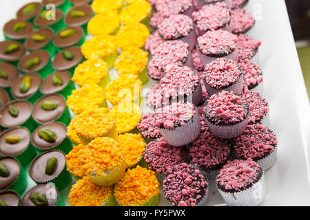 Colorful chocolate candies lay on a market counter, photo with selective focus Stock Photo