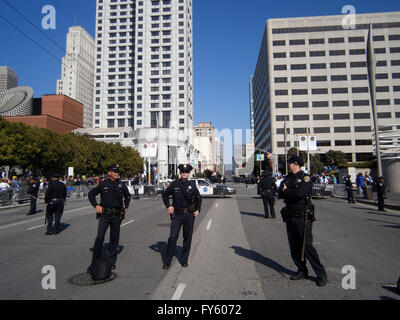 SAN FRANCISCO, CA - OCTOBER 25: SFPD Police officers stand on blocked street as protesters of Marijuana rights stand behind fence along Howard street on October 25, 2011 in San Francisco. Stock Photo