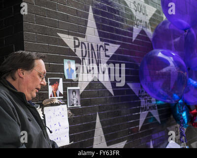 Minneapolis, MN, USA. 22nd Apr, 2016. A man pauses at a memorial to Prince in front of 1st Ave in Minneapolis. Thousands of people came to 1st Ave in Minneapolis Friday to mourn the death of Prince, whose full name is Prince Rogers Nelson. 1st Ave is the nightclub the musical icon made famous in his semi autobiographical movie ''Purple Rain.'' Prince, 57 years old, died Thursday, April 21, 2016, at Paisley Park, his home, office and recording complex in Chanhassen, MN. Credit:  Jack Kurtz/ZUMA Wire/Alamy Live News