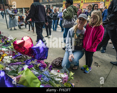 Minneapolis, MN, USA. 22nd Apr, 2016. A woman and her daughter look at a memorial for Prince at 1st Ave in Minneapolis. Thousands of people came to 1st Ave in Minneapolis Friday to mourn the death of Prince, whose full name is Prince Rogers Nelson. 1st Ave is the nightclub the musical icon made famous in his semi autobiographical movie ''Purple Rain.'' Prince, 57 years old, died Thursday, April 21, 2016, at Paisley Park, his home, office and recording complex in Chanhassen, MN. Credit:  Jack Kurtz/ZUMA Wire/Alamy Live News