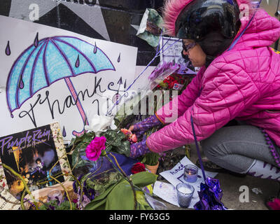 Minneapolis, MN, USA. 22nd Apr, 2016. MINA LEIERWOOD, from Minneapolis, MN, leaves a thank you card at a memorial for Prince in front of 1st Ave in Minneapolis. She said listened to Prince's music all through high school. Thousands of people came to 1st Ave in Minneapolis Friday to mourn the death of Prince, whose full name is Prince Rogers Nelson. 1st Ave is the nightclub the musical icon made famous in his semi autobiographical movie ''Purple Rain.'' Prince, 57 years old, died Thursday, April 21, 2016, at Paisley Park, his home, office and recording complex in Chanhassen, MN. (Cr