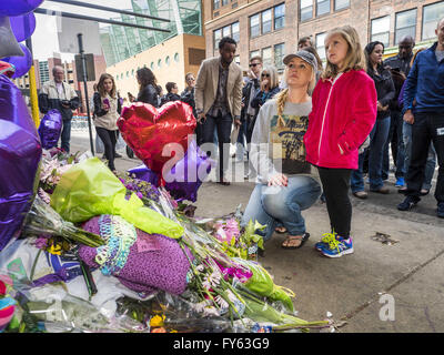 Minneapolis, MN, USA. 22nd Apr, 2016. A woman and her daughter look at a memorial for Prince at 1st Ave in Minneapolis. Thousands of people came to 1st Ave in Minneapolis Friday to mourn the death of Prince, whose full name is Prince Rogers Nelson. 1st Ave is the nightclub the musical icon made famous in his semi autobiographical movie ''Purple Rain.'' Prince, 57 years old, died Thursday, April 21, 2016, at Paisley Park, his home, office and recording complex in Chanhassen, MN. Credit:  Jack Kurtz/ZUMA Wire/Alamy Live News