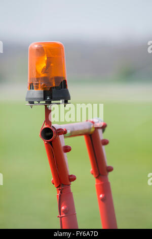Orange flashing light on a cell red metal scaffolding Stock Photo