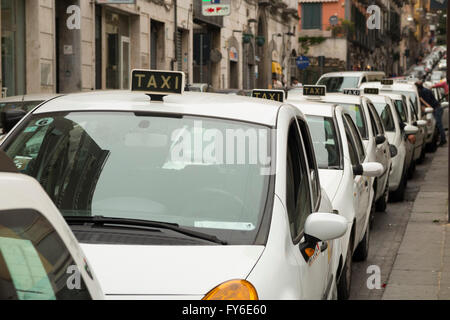 Taxis queuing / queue and wait for passengers at a taxi rank in Naples ( Napoli ) Italy. Stock Photo