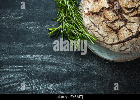 Home baked bread, food border background, dark slate with copy space Stock Photo