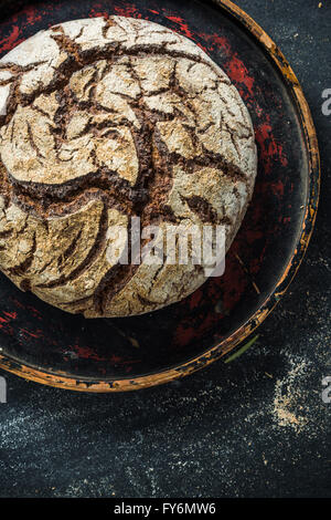 Rye bread loaf on dark slate, from above with copy space Stock Photo