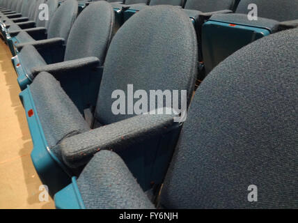 Curved Rows of Light Blue Cloth Seat with armrests in a theater. Stock Photo
