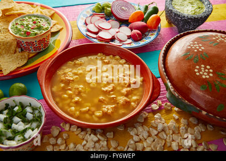 Green Pozole verde with blanco mote corn and ingredients on colorful table Stock Photo