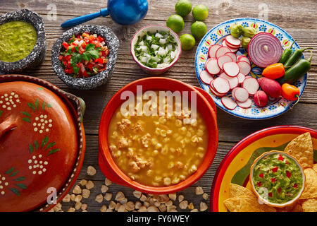 Green Pozole verde with blanco mote corn and ingredients on wooden table Stock Photo