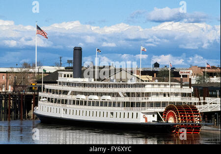 The historic 1927 Delta King riverboat is now a unique hotel permanently moored on the Sacramento River in Old Sacramento, California, USA. Originally the paddle-wheeler transported passengers on 10-hour voyages to and from San Francisco, then served the U.S. Navy in San Francisco during World War II. After her engines were salvaged for use in her sister ship, the Delta Queen, the old wooden riverboat was towed back to Sacramento for complete renovation. The Delta King came to life again in 1989 as this dockside hotel with 44 staterooms, a restaurant, bar and grill, and dinner theater. Stock Photo