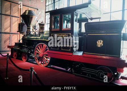 A very small 1863 steam locomotive named the C.P. Huntington for an early American railroad magnate is displayed in the California State Railroad Museum in Sacramento, California, USA. The historic train engine was used in the construction of the nation's transcontinental railroad, and then saw duty on the Southern Pacific Railroad before being retired in 1900. It is one of 21 restored vintage locomotives and railcars on permanent exhibit at the popular museum, which is adjacent to Old Sacramento State Historic Park. Stock Photo