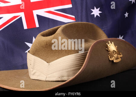 Australian Army slouch hat with rising sun badge against an Australian flag Stock Photo