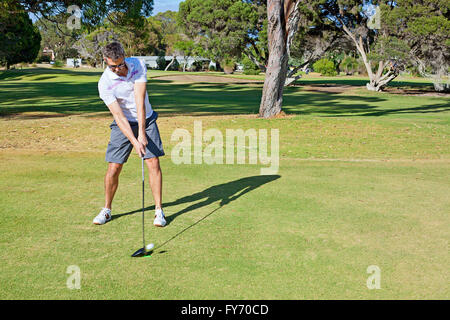 A golfer hitting the ball on a tee shot, teeing off, Perth, Australia