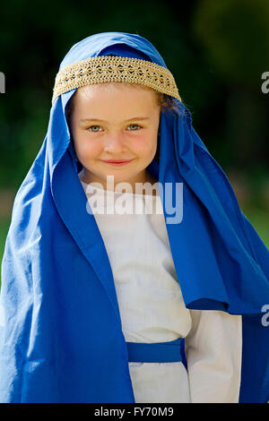 Little girl dressed as Mary for school nativity play Stock Photo