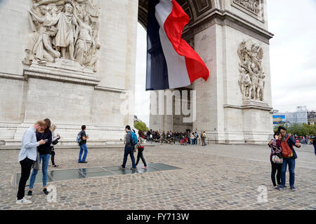 French National flag flying under Arc de Triomphe, Paris,France Stock Photo