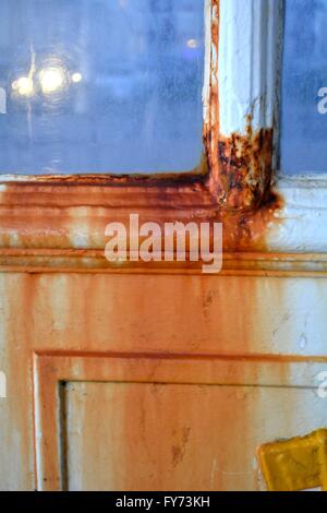 rust on a blue painted door Stock Photo