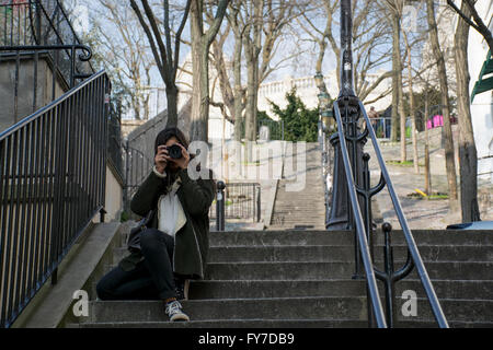 A woman snapping a picture with a DSLR camera Stock Photo