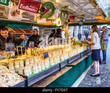 Women buying white asparagus from farmers market stall on Schillerplatz, Stuttgart, Baden-Württemberg, Germany Stock Photo