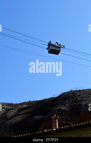 Orthodox priests inside a cable car suspended above Great Meteoron monastery in Greece Stock Photo