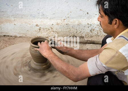 Man making clay bowl on potting wheel in village of Chandaleo Stock Photo