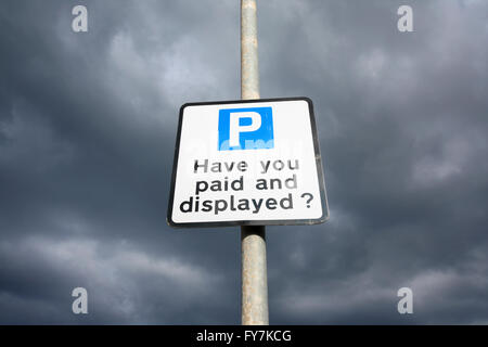 Have you paid and displayed sign against blue sky Stock Photo