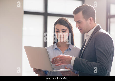 Nice colleagues using laptop Stock Photo