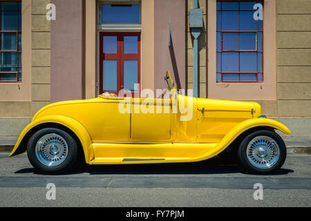 Adelaide, Australia - February 9, 2014: Yellow custom hot rod parked on the street on a bright day Stock Photo