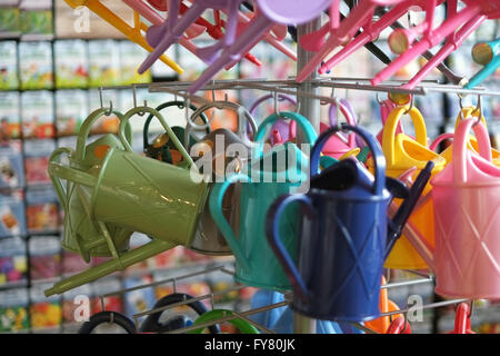 Watering cans in a garden centre shop. Stock Photo