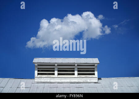 Single cloud over a white barn roof on Boon Hall Plantation in Charleston, South Carolina Stock Photo