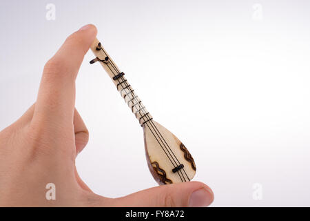 Hand holding the classic turkish instrument Saz Stock Photo