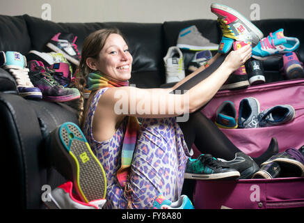 A young girl with a large collection of trainers UK Stock Photo