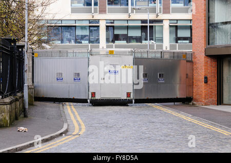 A metal mobile Police Cordon barrier blocks off a street in Belfast during a parade. Stock Photo