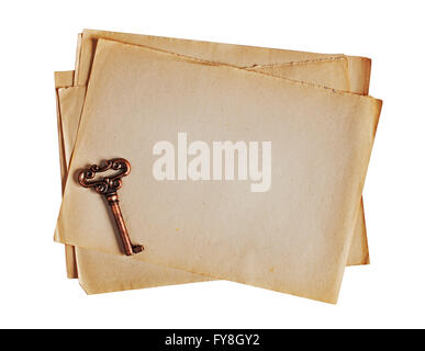 Old paper and bronze key isolated on white Stock Photo