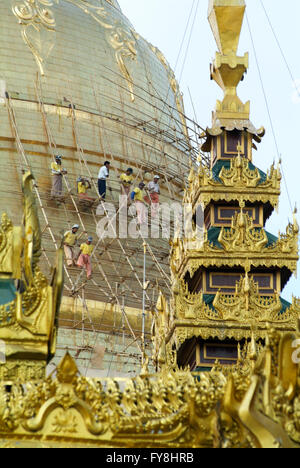 Yangon, Myanmar - 9 January 2010: Workers  repairing the stupa of the Shwedagon Pagoda in Yangon on Myanmar Stock Photo