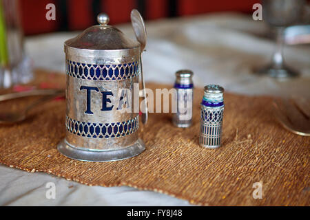 Antique tea set with spoon on the table Stock Photo