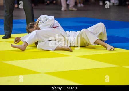 Two girls judoka in kimono compete on the tatami Stock Photo