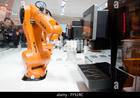 Hanover, Germany. 23rd Apr, 2016. The Cooffe 4.0 system, consisting of an app and a robot, makes coffe at the exhibition booth of Kuka at Hanover fair in Hanover, Germany, 23 April 2016. The world's biggest industry fair Hanover Messe is being opened by US-President Obama on 24 April. The United States of America are this year's partnering country. PHOTO: JULIAN STRATENSCHULTE/dpa/Alamy Live News Stock Photo