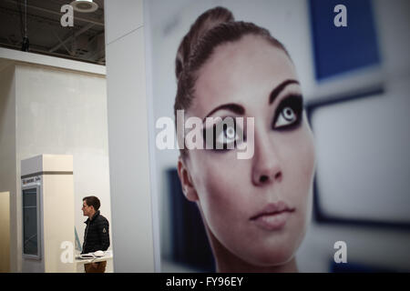 Hanover, Germany. 23rd Apr, 2016. A staff member works at an exhibitor's stand prior to the 2016 Hanover Industrial Trade Fair in Hanover, Germany, on April 23, 2016. The world's leading fair for industrial technology, attended by about some 5000 exhibitors, would take place from April 25 to 29 with the United States as this year's partner country. © Zhang Fan/Xinhua/Alamy Live News Stock Photo
