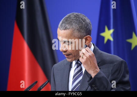 Hanover, Germany. 24th Apr, 2016. US President Barack Obama holds up an earpiece during a press conference at Herrenhausen Palace in Hanover, Germany, 24 April 2016. US President Obama is on a two-day visit to Germany. Photo: MICHAEL KAPPELER/dpa/Alamy Live News Stock Photo