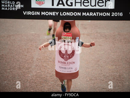 The Mall, London, UK. 24th April, 2016. 2016 Virgin London Marathon, a bottle of beer crosses the finish line, winning Greg Trevelyan Guinness World Record fastest marathon dresses as a bottle. Credit:  sportsimages/Alamy Live News Stock Photo