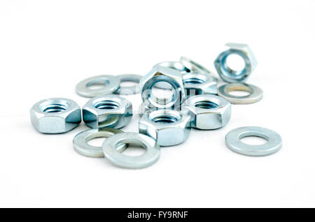 Several metal screw washers and nuts isolated on white background. Stock Photo