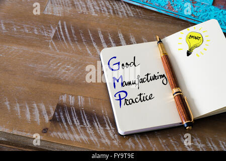 Conceptual Business Acronym GMP Good Manufacturing Practice. Retro effect and toned image of a fountain pen on a notebook Stock Photo