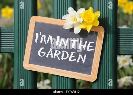 I'm in the garden with flowers flower spring sign board on fence Stock Photo